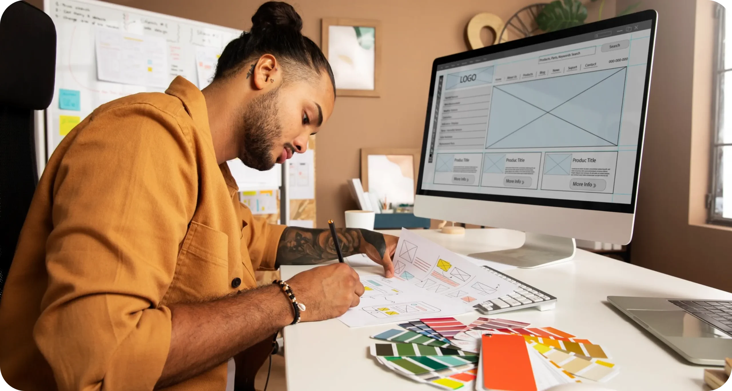 Creative designer planning digital layouts on paper and computer for Social Media Marketing Services in a modern office setup.